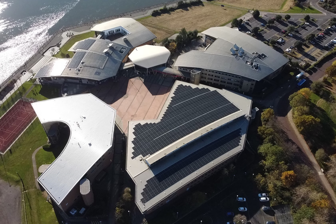 Aerial view of university campus and solar panels