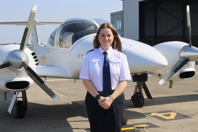 Woman standing infront of a plane
