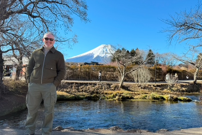 Apprentice stood in front of Mount Fuji