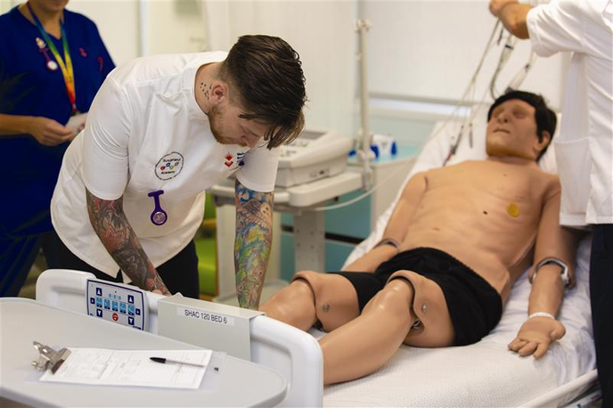 Nursing student training on a mannequin