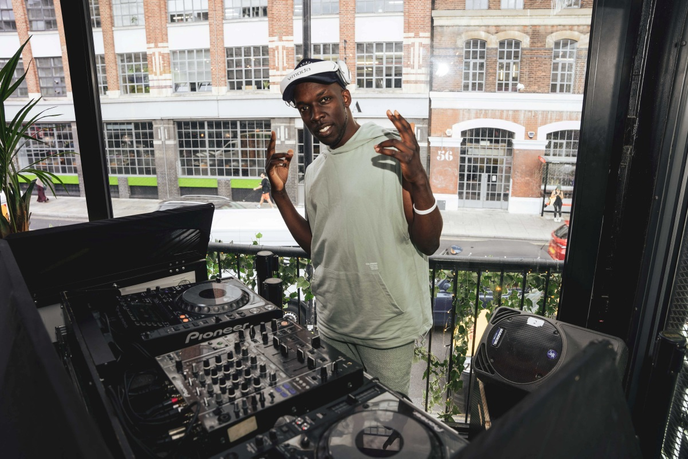 Graduate stood behind DJ Deck