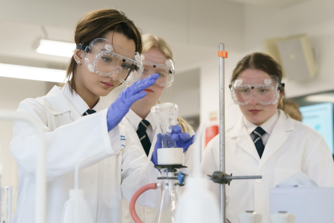 Students taking part in an experiment with beakers