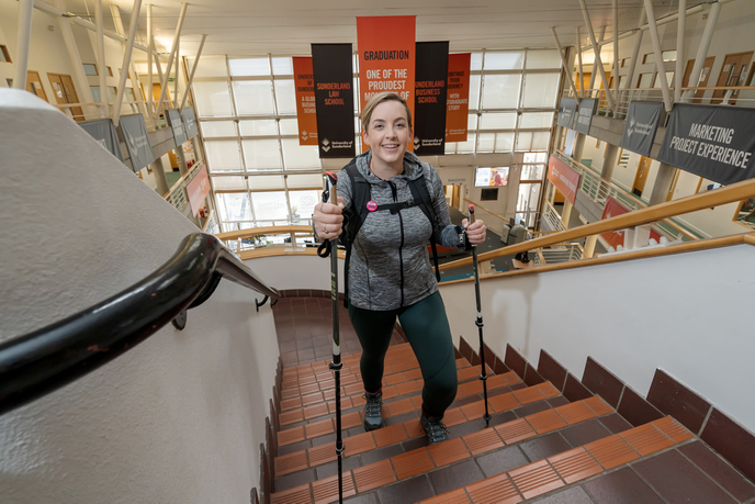 Academic with hiking gear on stairs