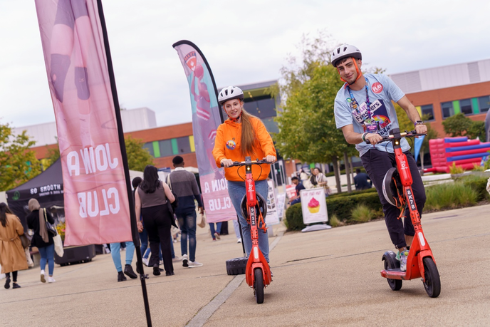 Students on Electric scooters on campus