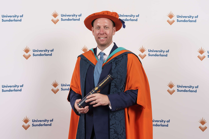 Honorary graduate in cap and gown