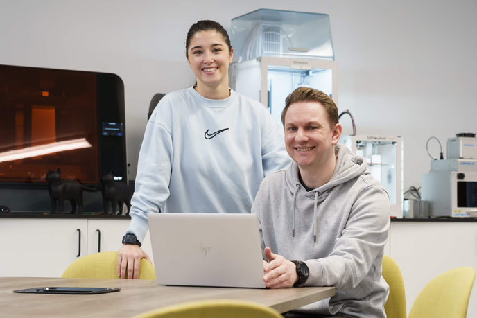 Apprentices sat at a table with a laptop