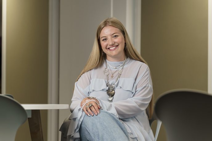 Graduate sat on chair