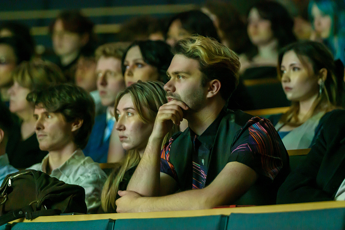 Students in lecture hall watching a film