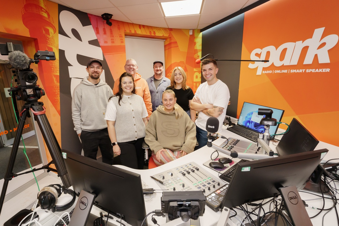 Presenters and Producers stood in a radio studio