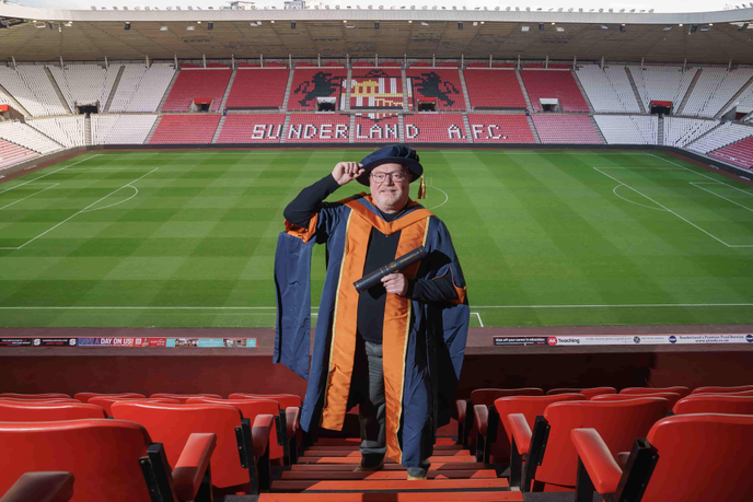 Man standing in football stadium