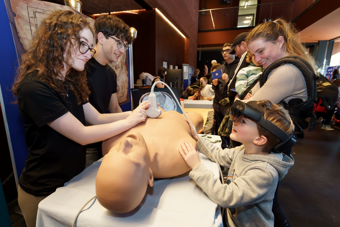 Children exploring an ultrasound stall at event
