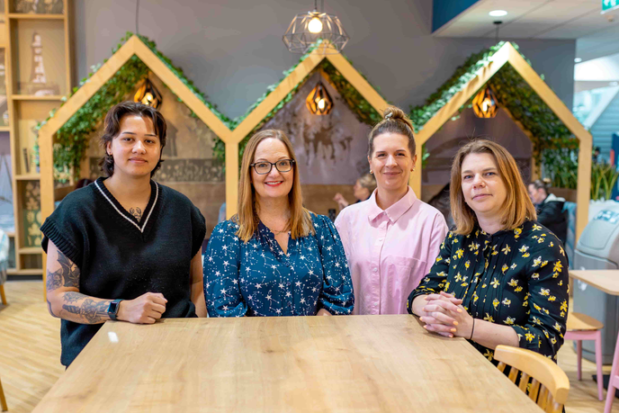 Staff stood together in front of a table