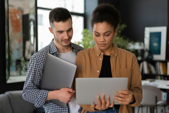 People looking at a laptop in an office