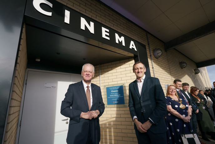 Sir David Bell and Lewis Atkinson, MP for Sunderland Central, standing outside the new cinema sign