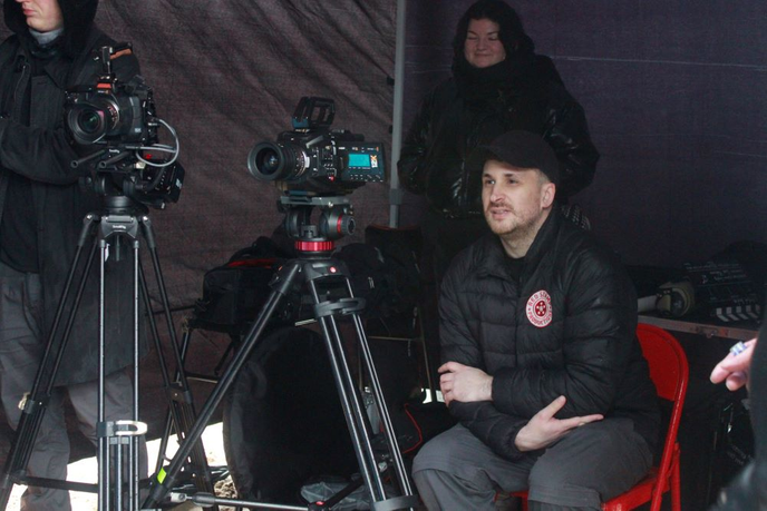 Film student sitting with camera