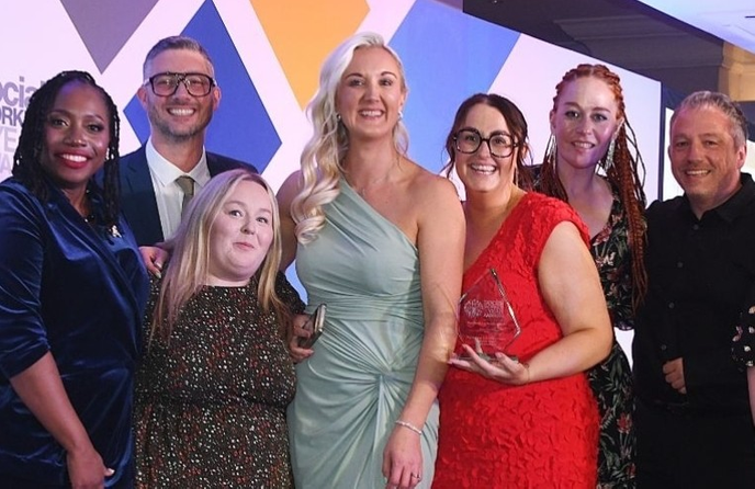 Group of people standing with an award