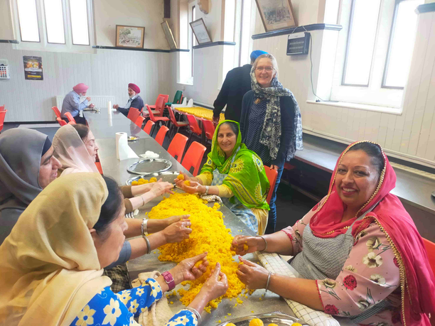 Volunteers cooking together on a table