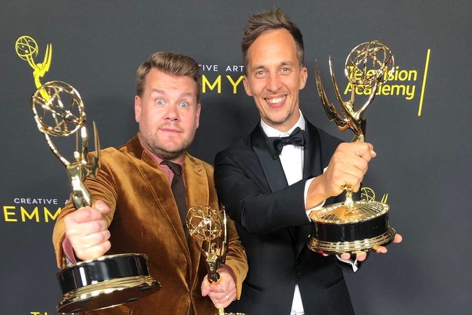 Two men holding awards