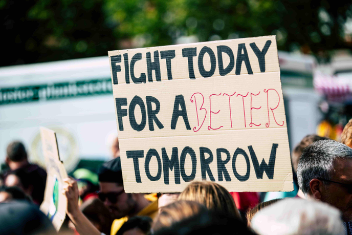 Protestors holding up a sign
