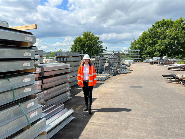 Olivia standing outside next to construction equipment at Birtley Group