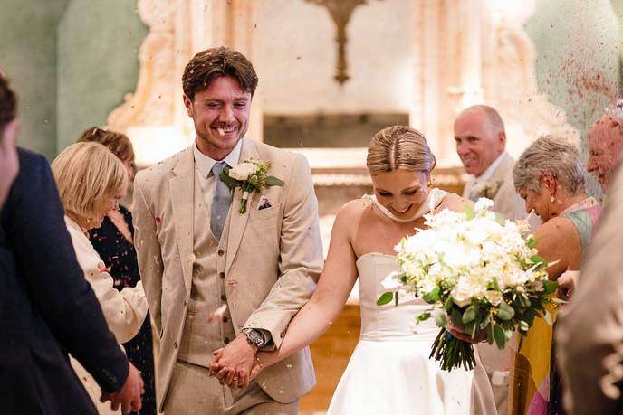 Graduates walking down the aisle at their wedding