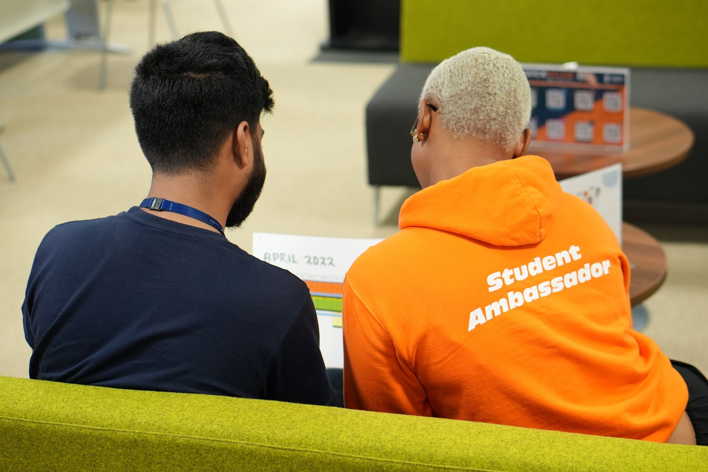 A student ambassador helps a student with their timetable