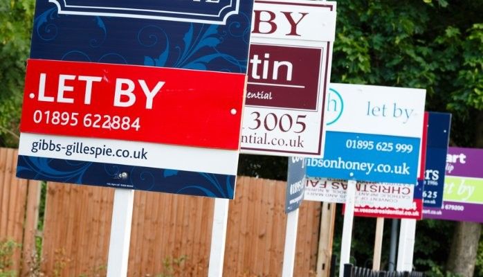 Different letting agent signs in a row