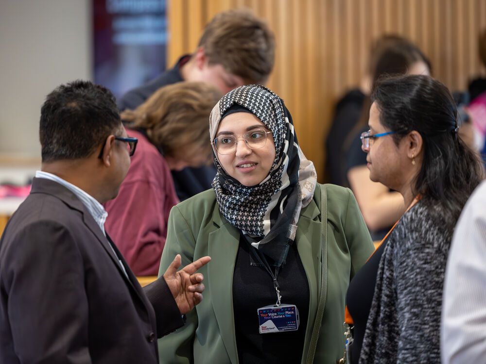 Three members of staff chatting during an Open Day