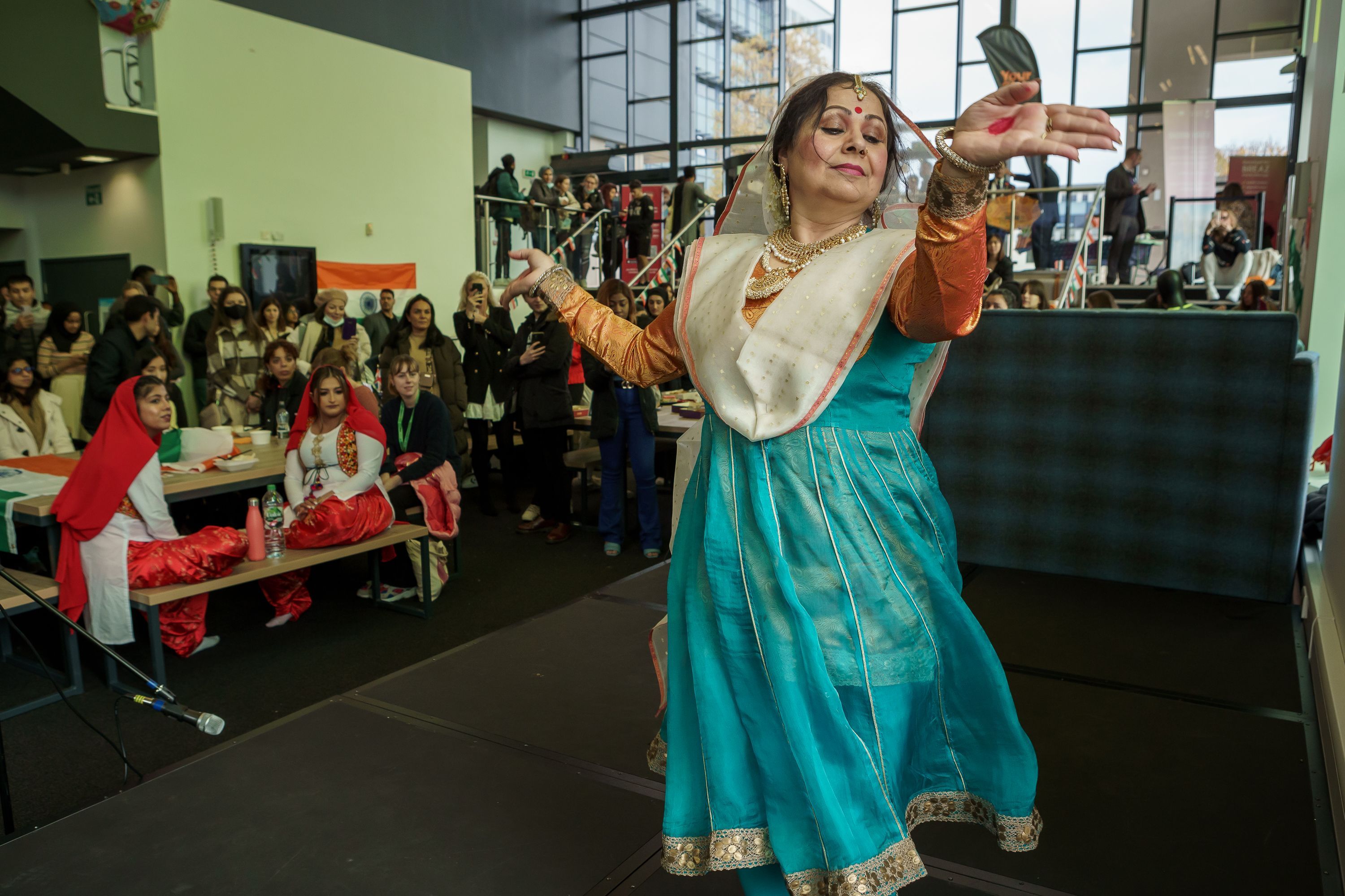 A person dancing in traditional indian clothing as part of india day