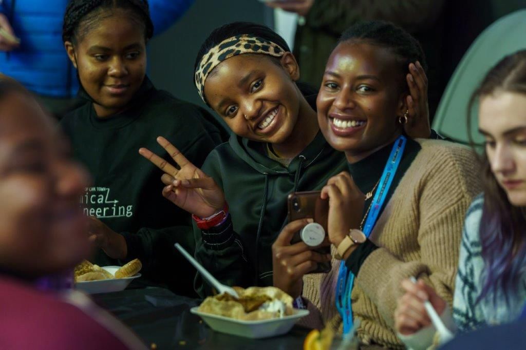 A group of students eating food at the global food festival