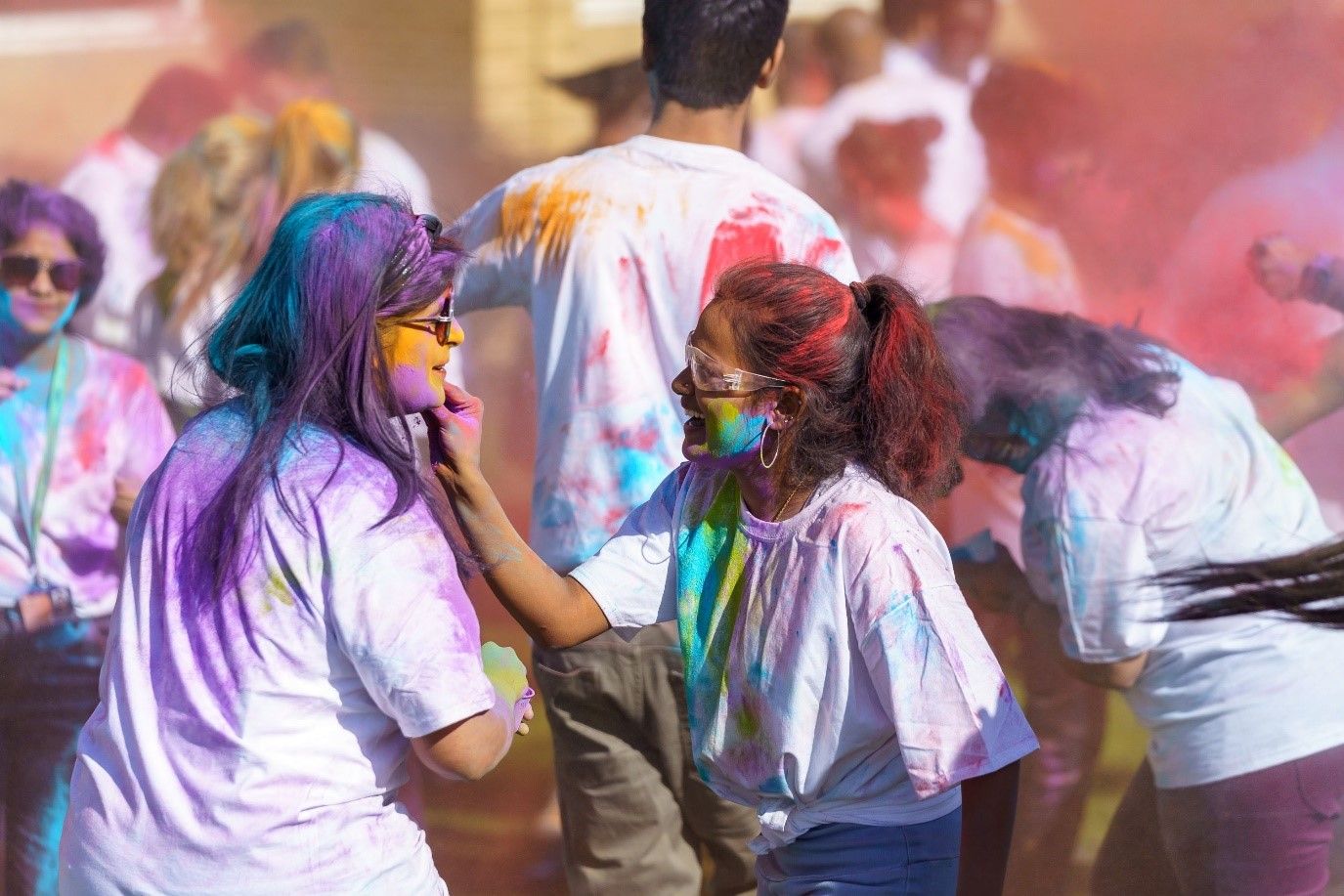 Two students celebration Holi with coloured paint