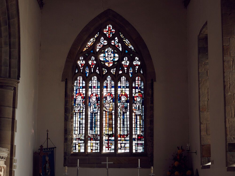 A large stain glass window in a church