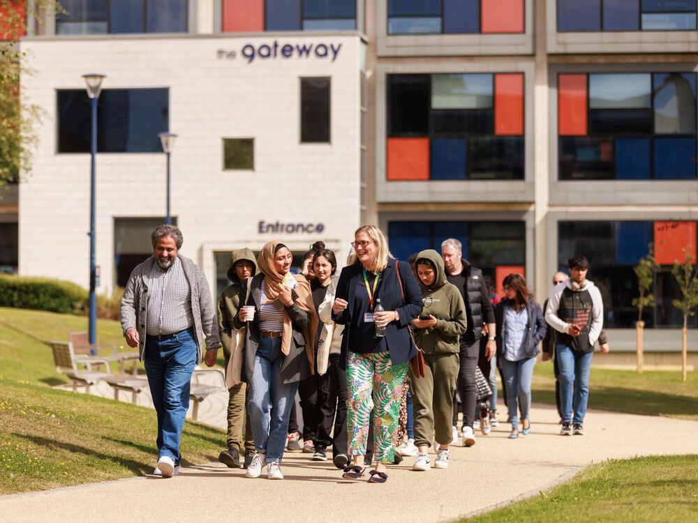 An academic leading a group of Open Day visitors across City Campus