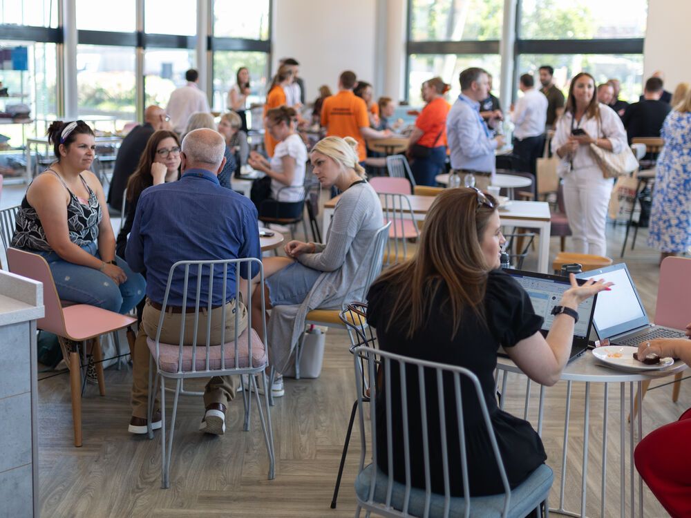 A large group of people at a conference networking