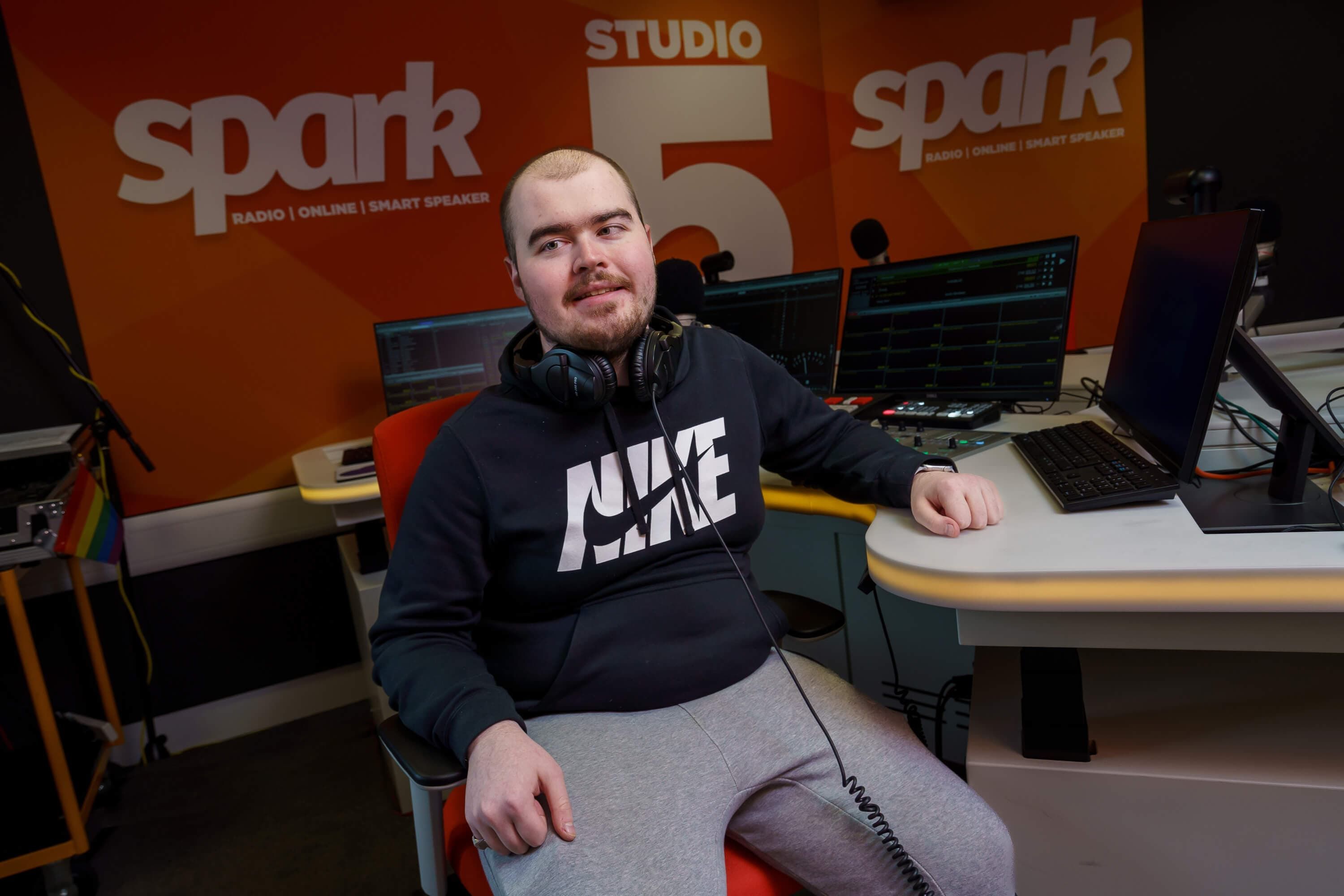 A student sitting in the Spark radio station room