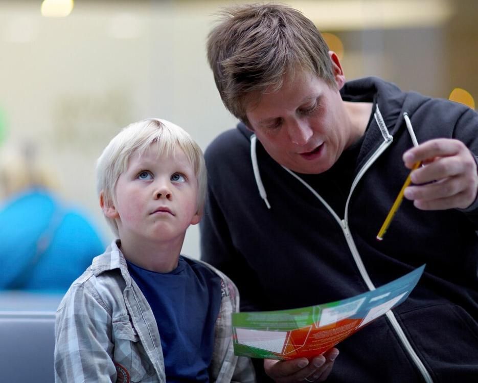 A father reading to his young child