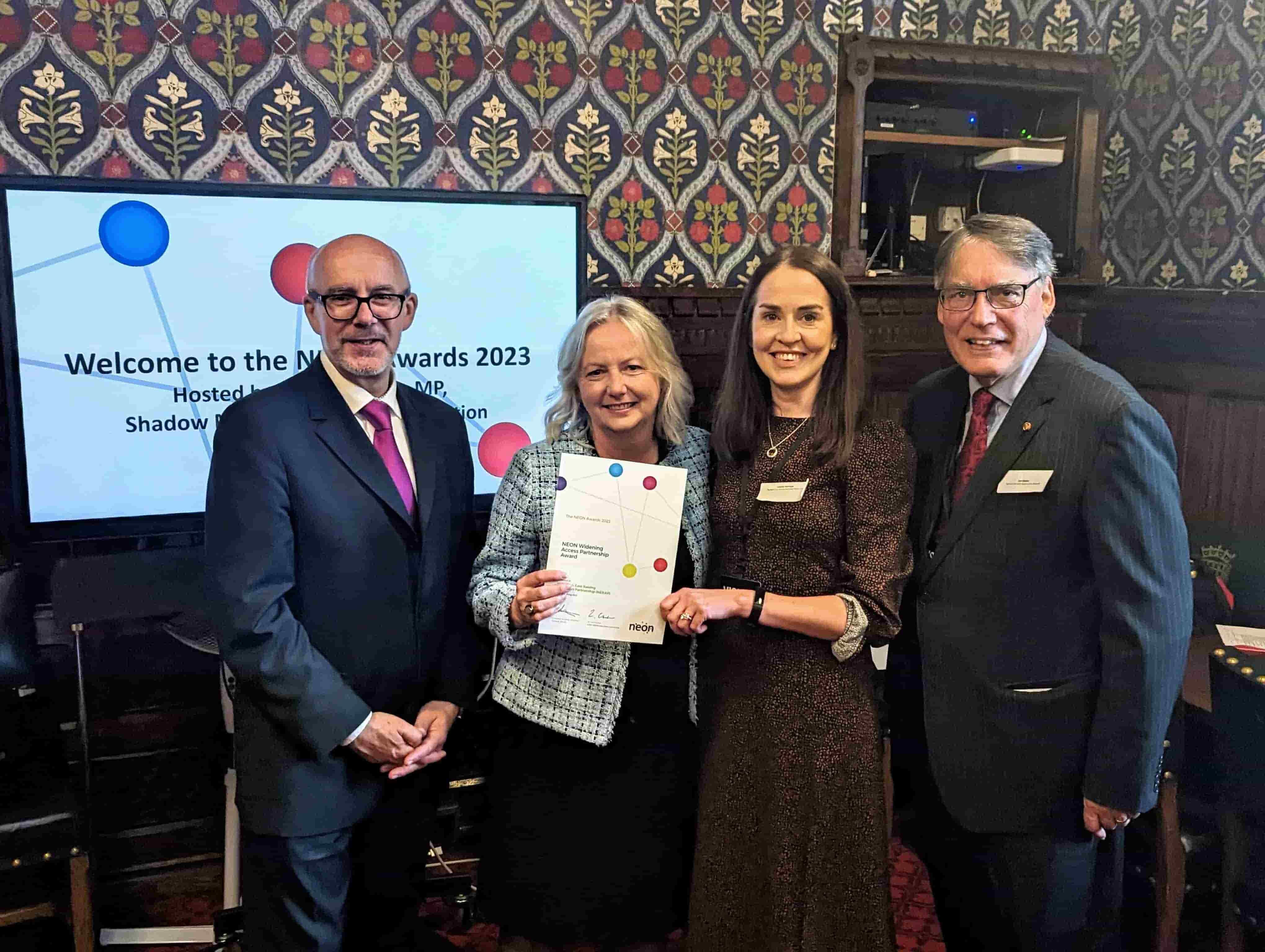 A group of people holding a certificate