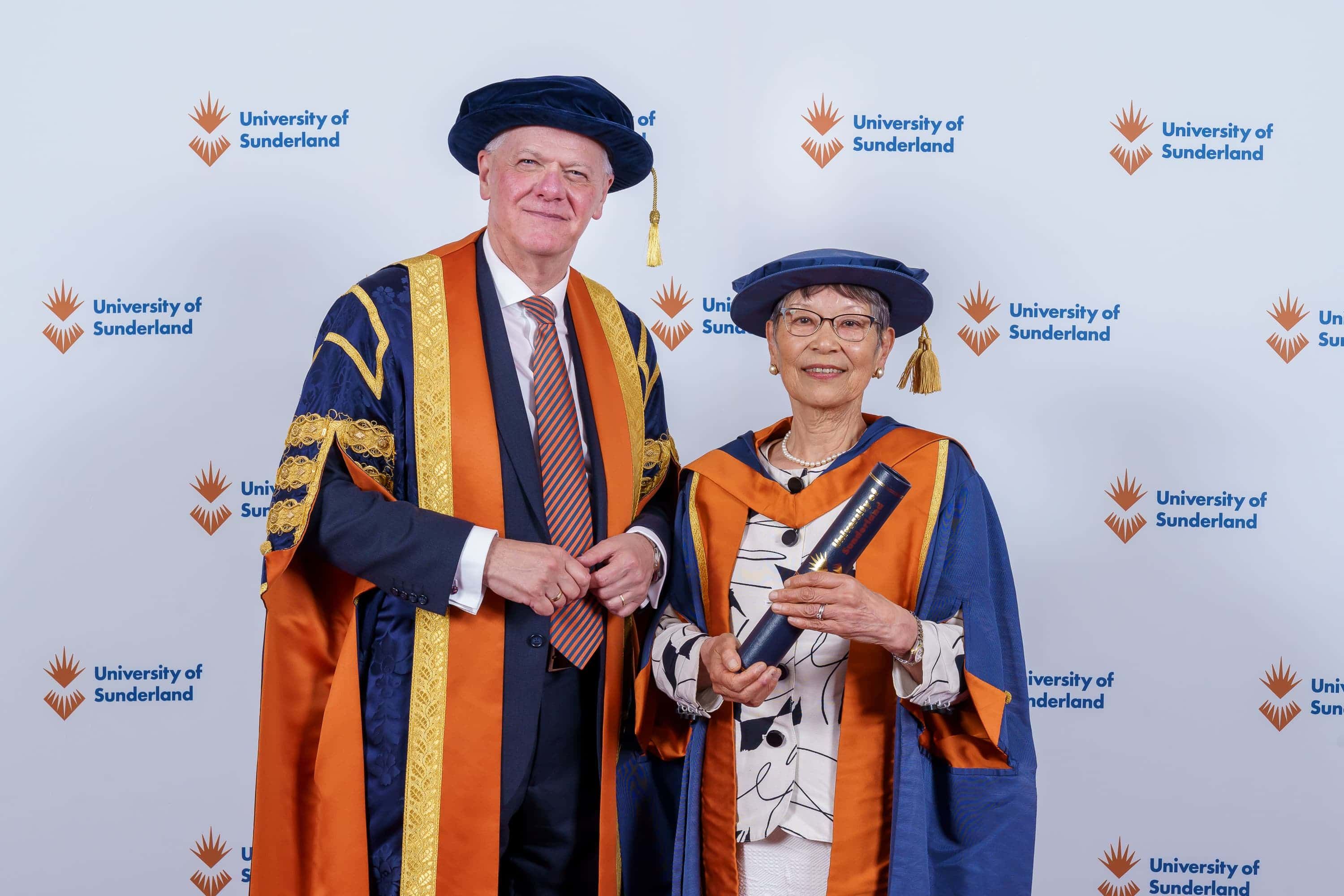 Sayoko Smith on graduation day with Sir David Bell