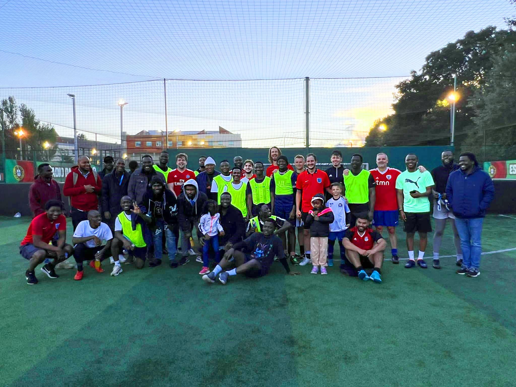 The staff and Nigerian Society football teams posing together as a group