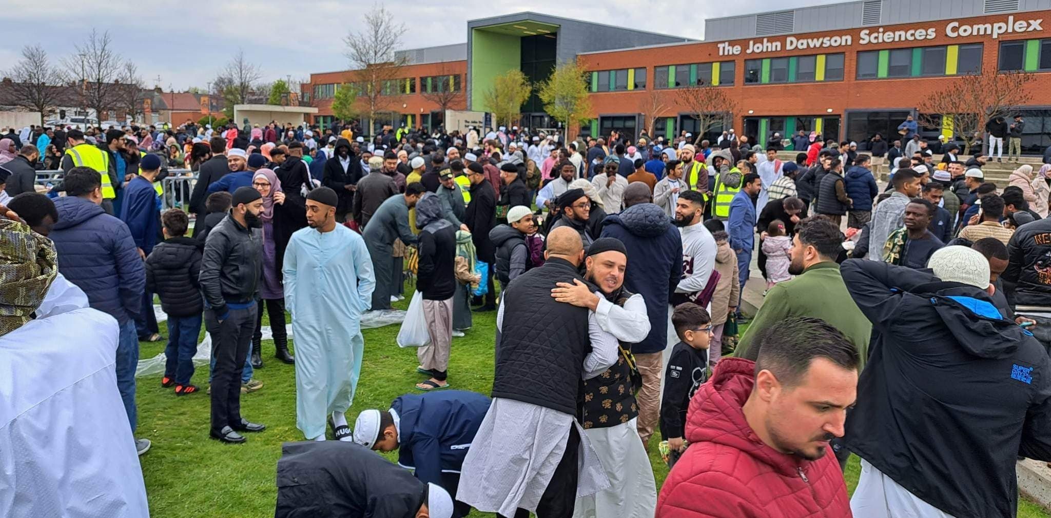 Lots of people embracing one another after prayers had finished