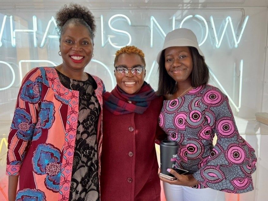 Three students smiling at the camera