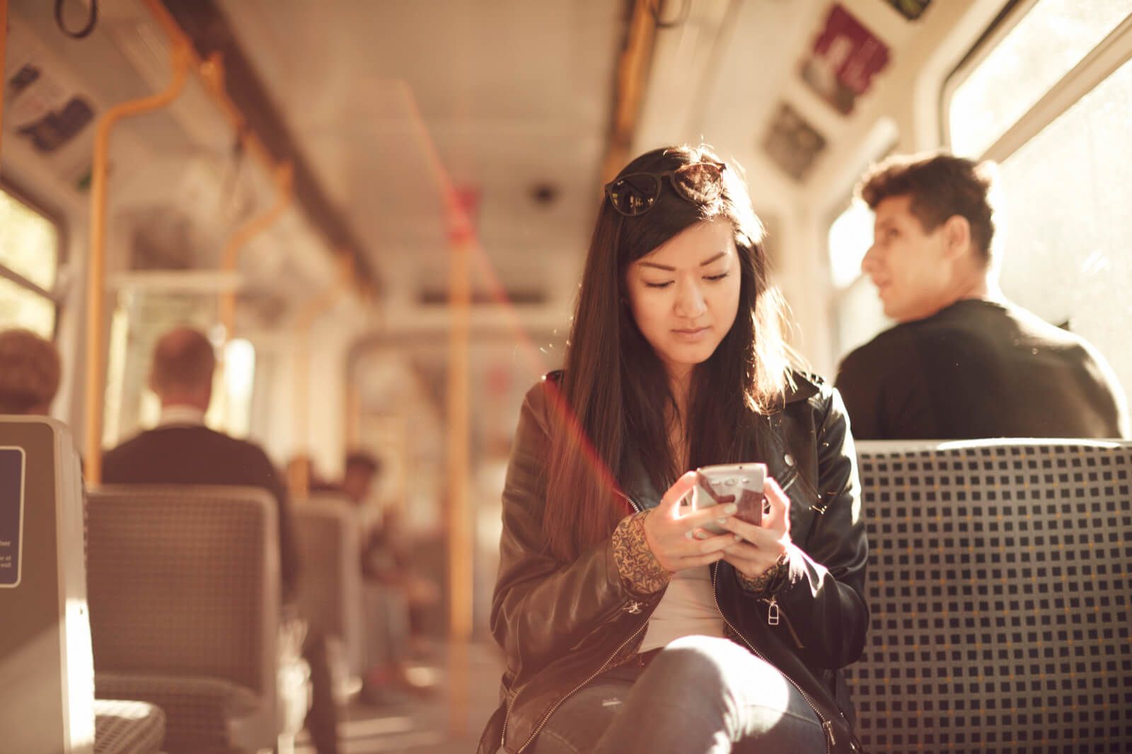 Student using her mobile on a train