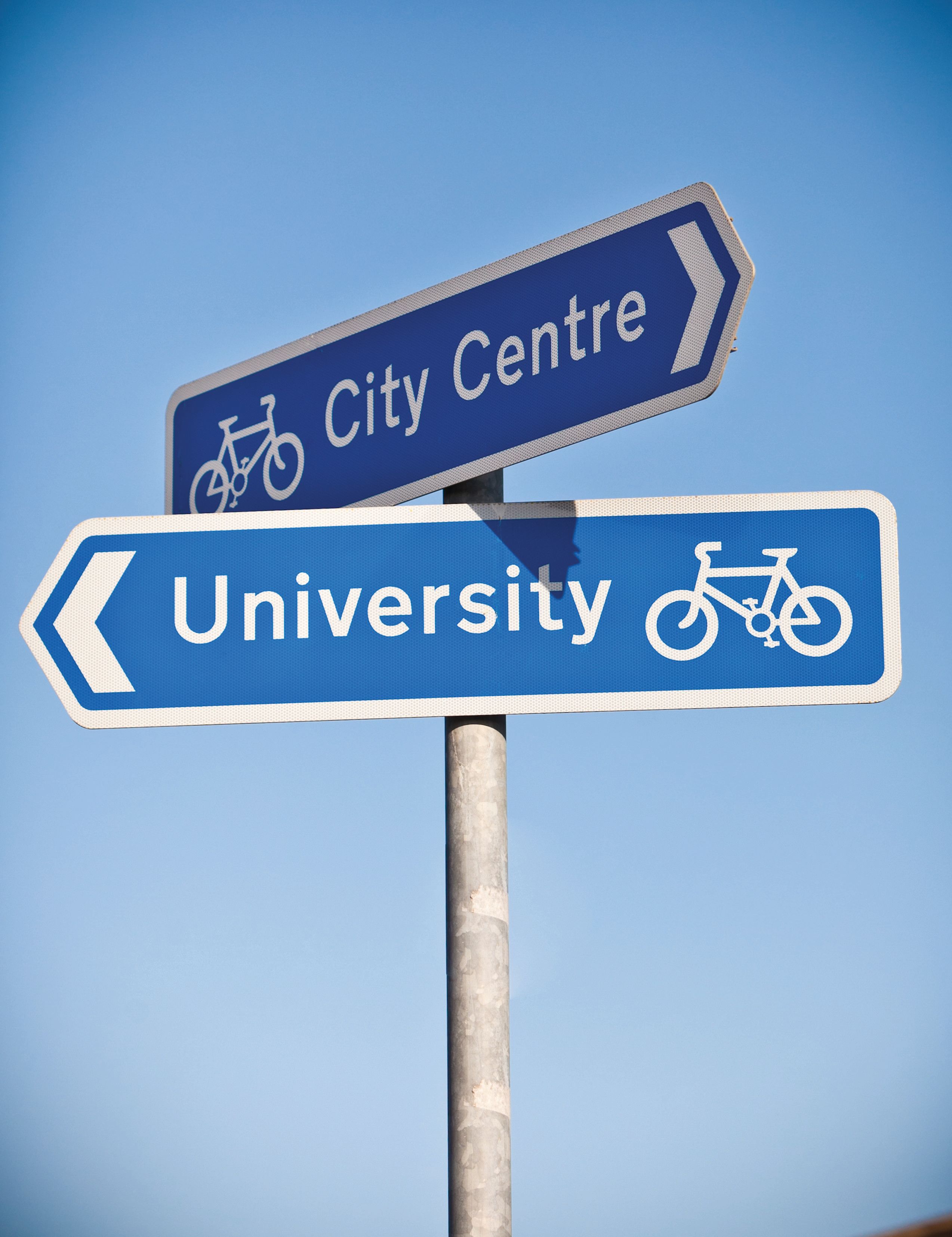 Two blue direction signs, pointing towards the City Centre and University