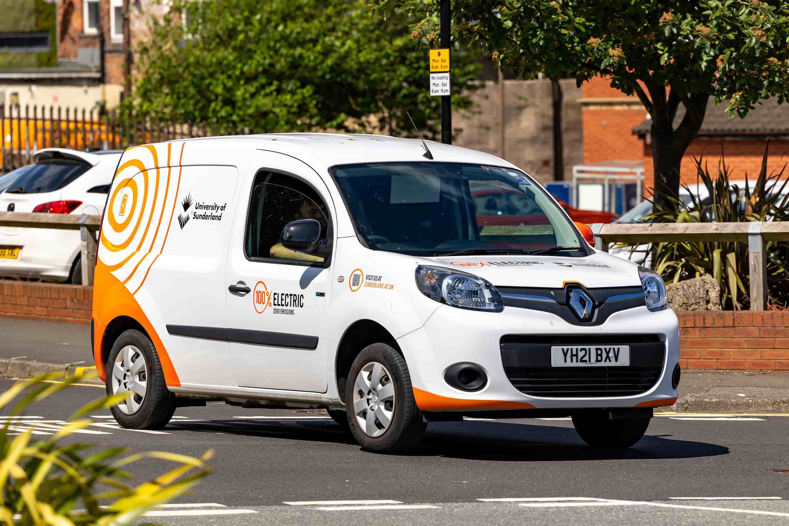 An University branded electric vehicle driving on campus