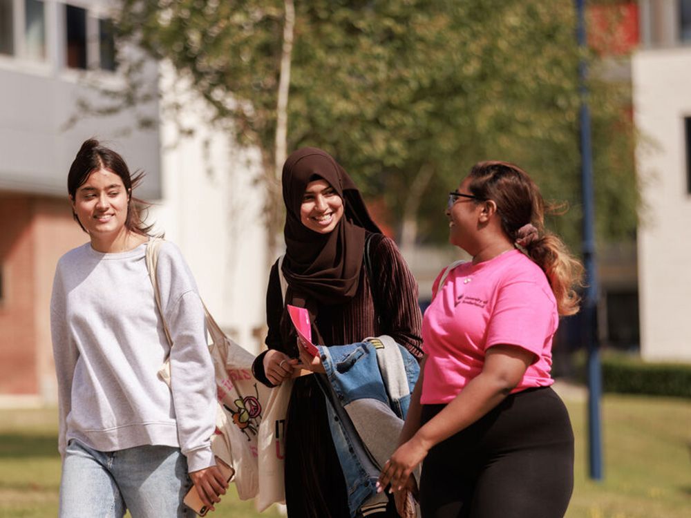 A Student Ambassador showing two potential students around campus