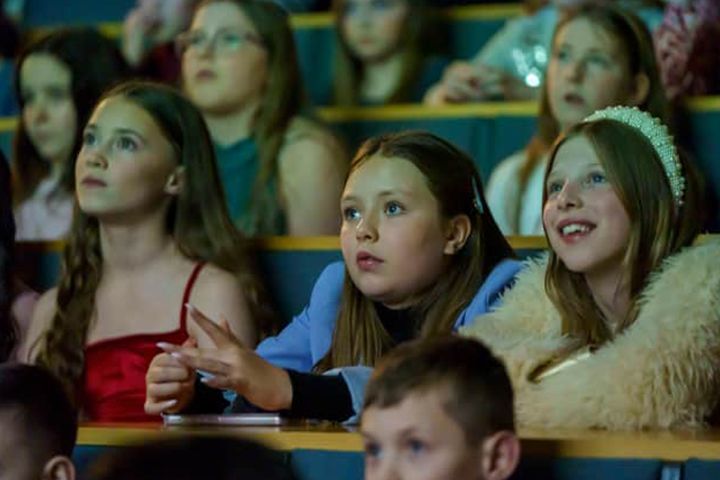 A group of school students watching a film in the Sir Tom Cowie Lecture Theatre