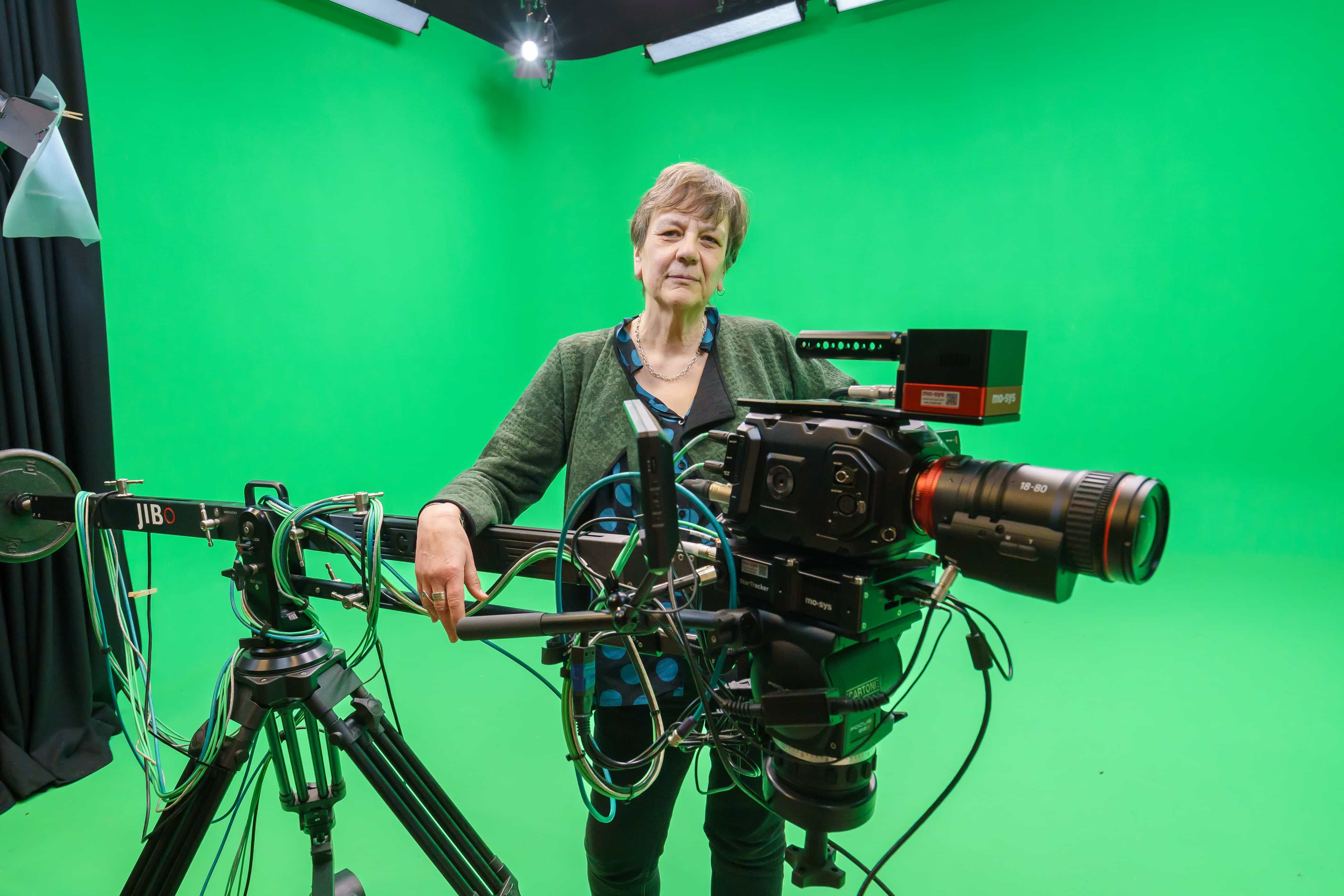 Professor Arabella Plouviez, Dean of the Faculty of Arts and Creative Industries standing next to a camera in the Chroma studio
