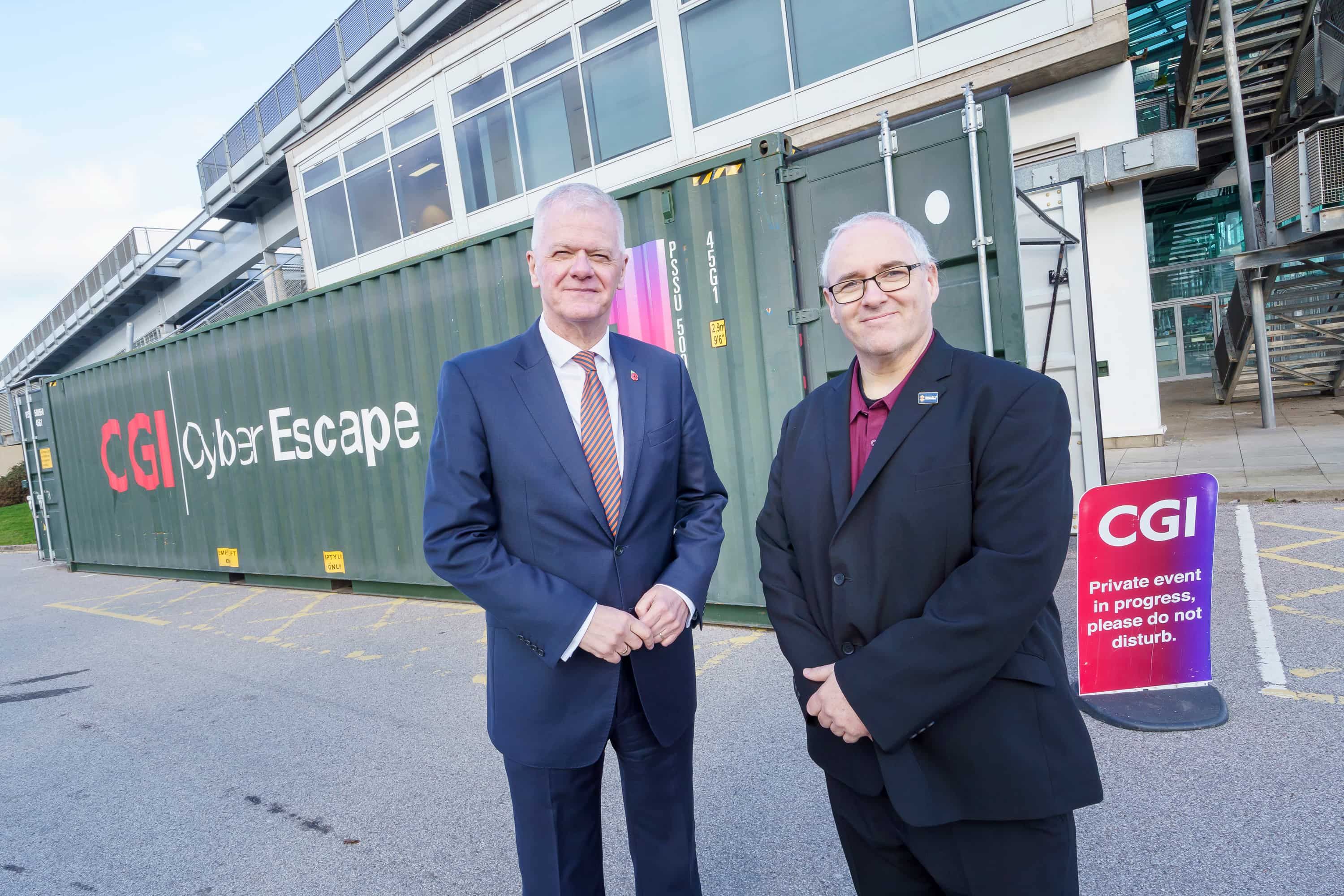 Sir David Bell and Professor John Murray standing next to each other outside the CGI cyber escape room