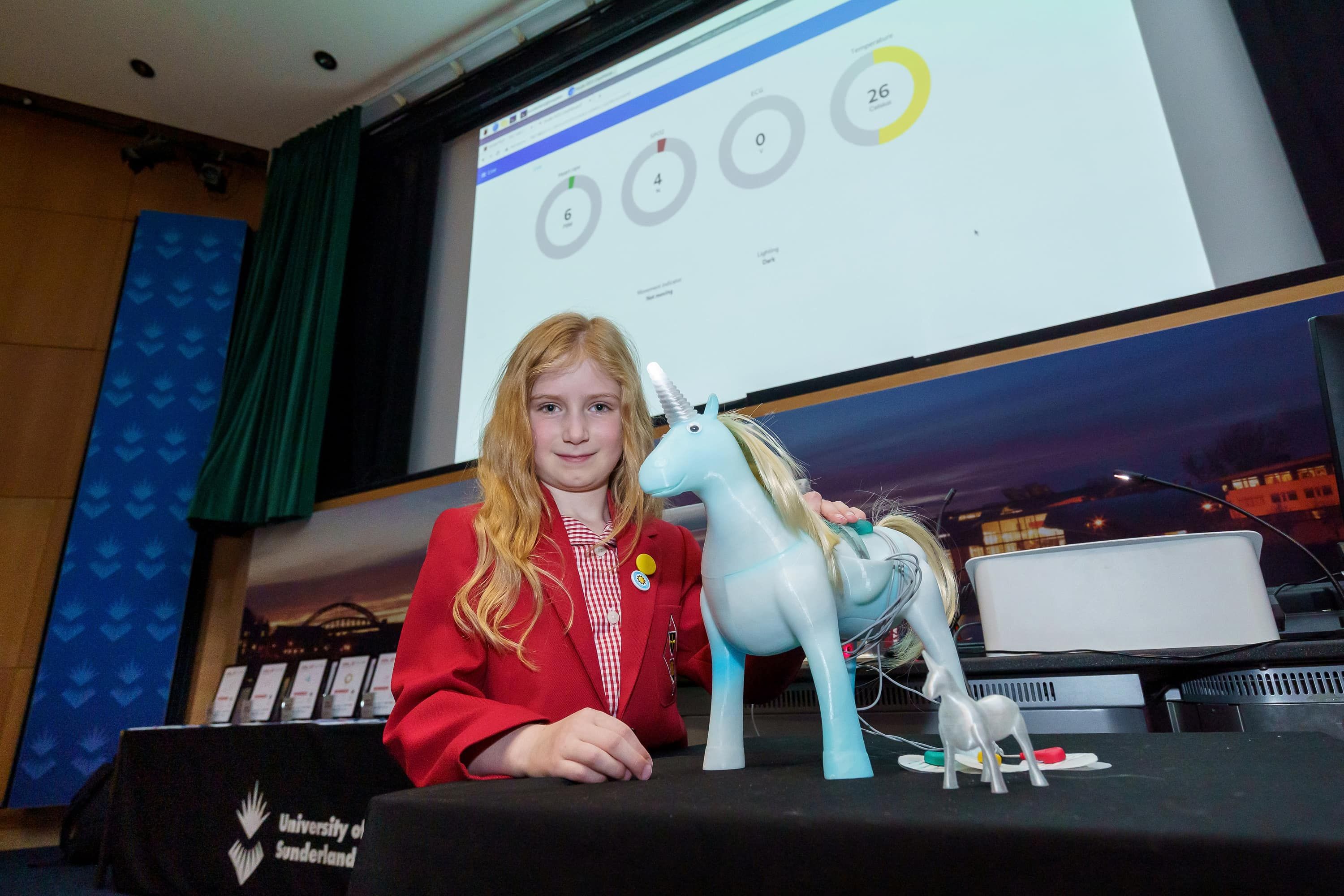 Francesca Mobberley standing with her Unicorn Health Bot