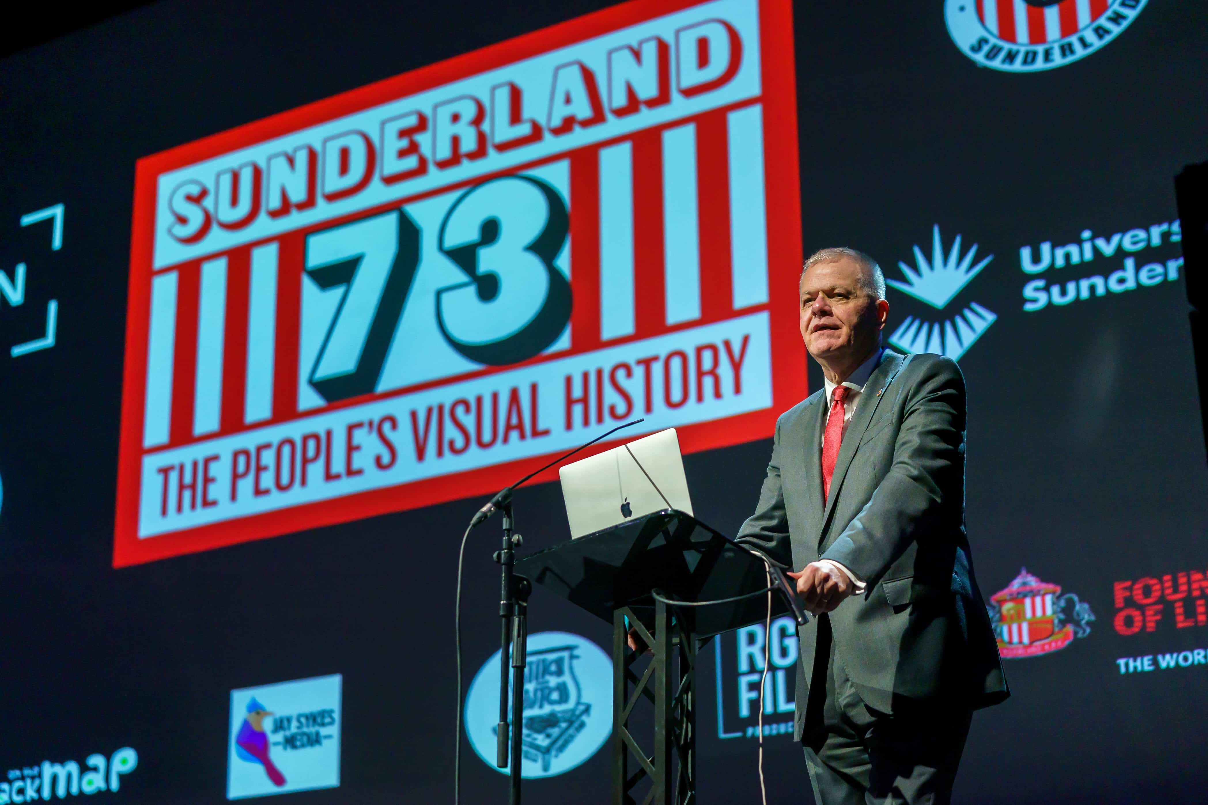 Sir David Bell speaking at a podium at the Sunderland 73 The People’s Visual History book launch event